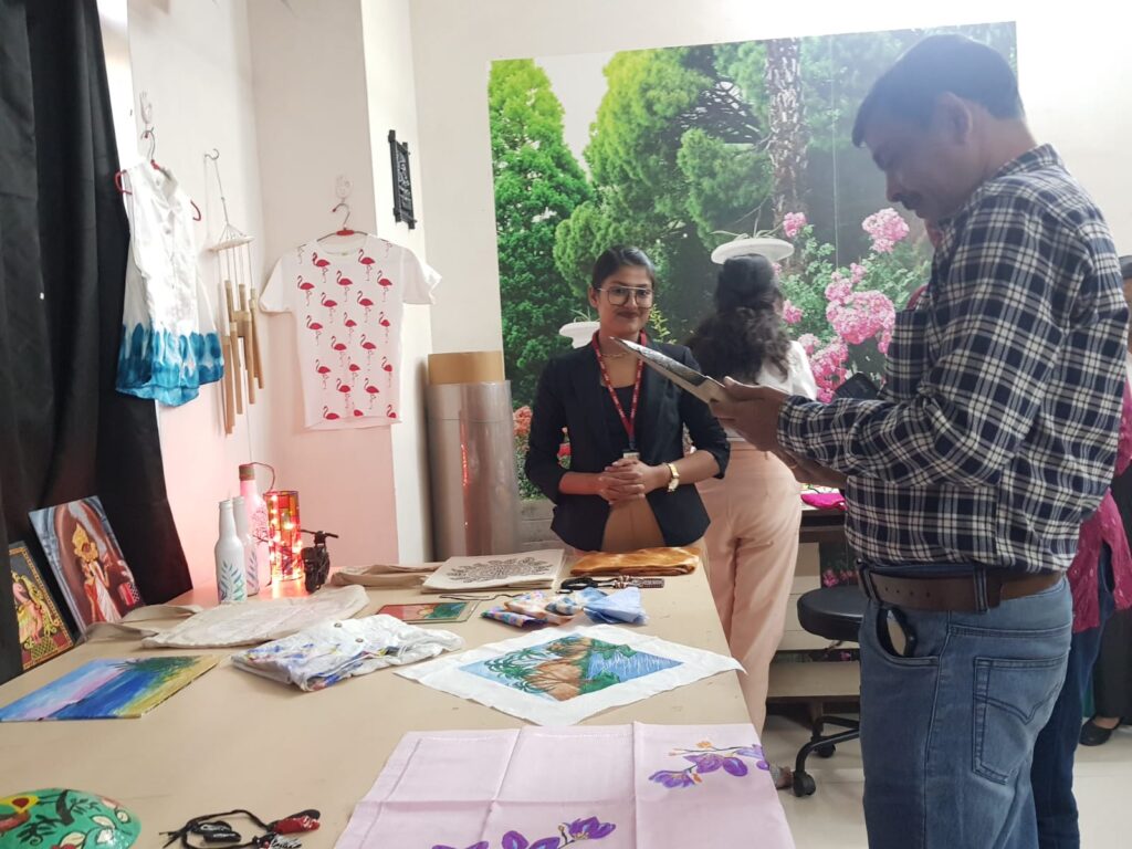 Students at INIFT Kolkata's interior design workshop engaging in a collaborative design charrette, exchanging ideas and sketches.